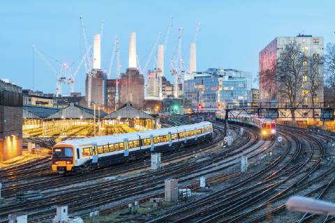United Kingdom, England, London, view of railtracks and trains in the evening, former Battersea Power Station and cranes in the background WPEF01263
