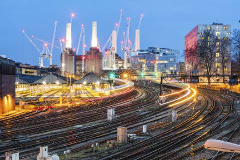 United Kingdom, England, London, view of railtracks and trains in the evening, former Battersea Power Station and cranes in the background WPEF01264