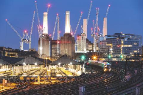 United Kingdom, England, London, view of railtracks and trains in the evening, former Battersea Power Station and cranes in the background WPEF01265