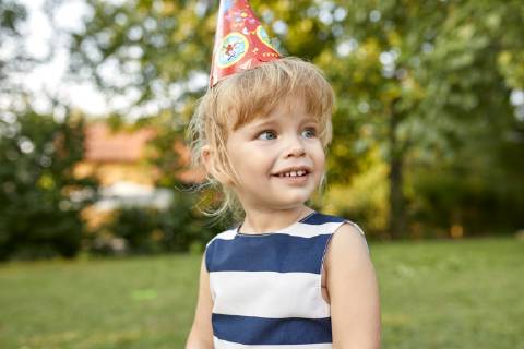Portrait of little girl on a birthday garden party wearing party hat model released Symbolfoto property released  ZEDF01654