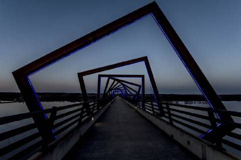 March 22, 2019 - Madrid, Iowa, U.S. - Originally a conduit for rail freight, but now a decomissioned railroad line, the High Trestle Trail Bridge is part of the 25-mile Trestle Trail path for bikers, hikers and horseback riders. The artistic, spiral steel frames springing up from the road bed are a nod to the shape of the timbers placed in former central Iowa coal mines. Madrid U.S. - ZUMAce6_ 20190322_zaf_ce6_020 Copyright: xBrianxCahnx