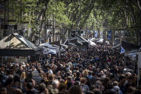 April 23, 2019 - Barcelona, Catalonia, Spain - A crowd of people seen circulating at the book stalls during the Sant Jordi day celebration..The festivity of Sant Jordi is celebrated in conjunction with Book Day and the Fair of Roses, symbols of culture and love. Knight Saint Jordi died on April 23, 303.The cult of Saint Jordi was established in Catalonia during the 8th century but it is at the end of the 19th century, with the Catalan Renaixenca that installed as the most celebrated patriotic, civic and cultural day in Catalonia. The streets of the cities and towns of Catalunya are filled with stalls with books and roses for sale. Tradition orders that man should give a rose to his partner and the woman a book in turn. Barcelona Spain - ZUMAs197 20190423_zaa_s197_071 Copyright: xPacoxFreirex