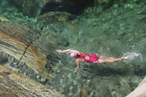 Switzerland, Ticino, Verzasca Valley, woman swimming in refreshing Verszasca river model released Symbolfoto  GWF05955