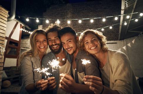 Freinds having a backyard party, burning sparklers model released Symbolfoto property released  PDF01885