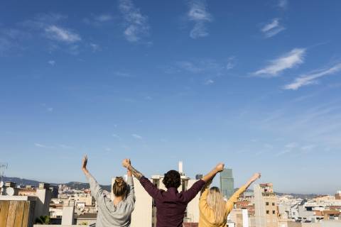 Friends having fun on an urban rooftop terrace, raising arms model released Symbolfoto  VABF02202