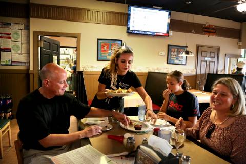 March 31, 2019 - Palm Harbor, Florida, U.S. - DOUGLAS R. CLIFFORD Times.Kelsey Gabrelcik serves Pinellas County Sheriff Bob Gualtieri, left, Lauren Gaultieri, 13, and Pasco Circuit judge Lauralee Westine during a recent dinner outing at Vetture s Pizzeria and Restaurant in Palm Harbor (3 31 19) Palm Harbor U.S. - ZUMAs70_ 20190331_zan_s70_038 Copyright: xDouglasxR.xCliffordx