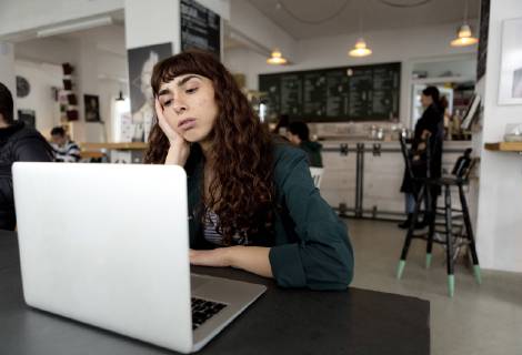 Frustrated young woman using laptop in a cafe model released Symbolfoto property released  FLLF00067