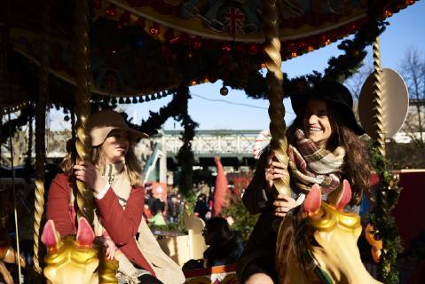 Two happy women having fun on a carousel model released Symbolfoto  IGGF01142
