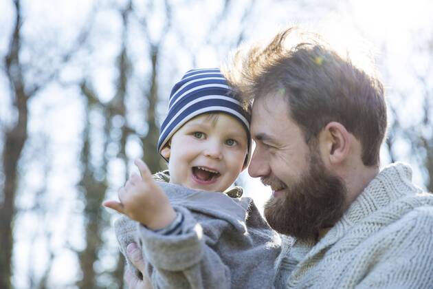 Happy father carrying son in park model released Symbolfoto MAEF12855