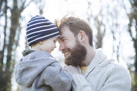 Happy father carrying son in park model released Symbolfoto MAEF12857