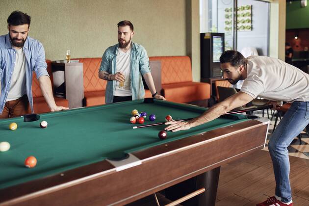 Friends playing billiards together model released Symbolfoto property released  ZEDF02044
