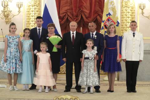 MOSCOW, RUSSIA - MAY 30, 2019: Russia s President Vladimir Putin (C) poses for a group photo with the Lusta family from Kaliningrad Region during a ceremony to present Orders of Parental Glory to parents of large families at the Moscow Kremlin. Mikhail Metzel TASS  TS0AD4F9