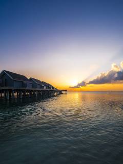Maledives, Ross Atoll, water bungalows at sunset AMF06908