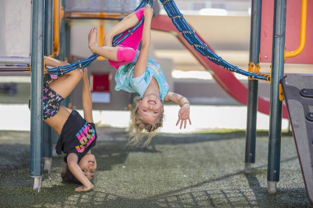 Happy girls playing on playground of a kindergarten model released Symbolfoto property released  ZEF15479