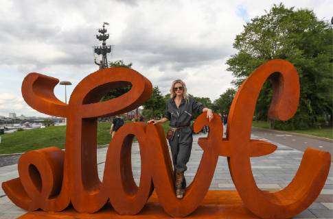 MOSCOW, RUSSIA - JULY 13, 2019: German contemporary artist Mia Florentine Weiss poses at her Love Hate mobile ambigram sculpture unveiled at Muzeon Park as part of her European tour in support of the LoveEurope art action. Stanislav Krasilnikov TASS  TS0B2FE8