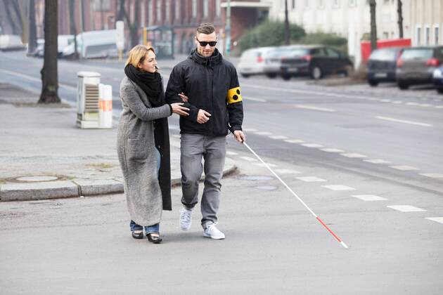 Woman Assisting Blind Man On Street ,model released, Symbolfoto  Copyright: xAndreyPopovx Panthermedia21371763