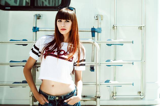  portrait attractive women in sports white T-shirt against background of Camper Trailer, transport for travel,model released, Symbolfoto  Copyright: xevgeniykleymenovx Panthermedia24173586