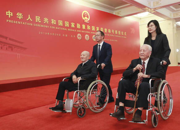 (190929) -- BEIJING, Sept. 29, 2019 -- Awardees of the Medal of the Republic Zhang Fuqing and Huang Xuhua prepare to enter the Golden Hall at the Great Hall of the People in Beijing, capital of China, Sept. 29, 2019. China held the presentation ceremony of the national medals and honorary titles on Sunday at the Great Hall of the People, ahead of the 70th anniversary of the founding of the People s Republic of China (PRC) on Oct. 1. ) CHINA-BEIJING-NATIONAL MEDALS-HONORARY TITLES-PRC FOUNDING-70TH ANNIVERSARY (CN) PangxXinglei 