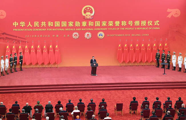 (190929) -- BEIJING, Sept. 29, 2019 -- Chinese President Xi Jinping, also general secretary of the Communist Party of China Central Committee and chairman of the Central Military Commission, delivers a speech at the presentation ceremony of the national medals and honorary titles of the People s Republic of China at the Great Hall of the People in Beijing, capital of China, Sept. 29, 2019. Xi presented the medals to the awardees before the speech. ) CHINA-BEIJING-NATIONAL MEDALS AND HONORARY TITLES-PRESENTATION CEREMONY (CN) YinxBogu 