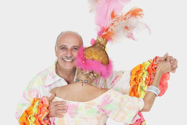 Portrait of senior couple in Brazilian outfits dancing over gray background,model released, Symbolfoto 03B94786