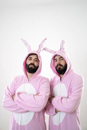 Two male friends with rabbit costumes in front of white background model released Symbolfoto  AFVF04147