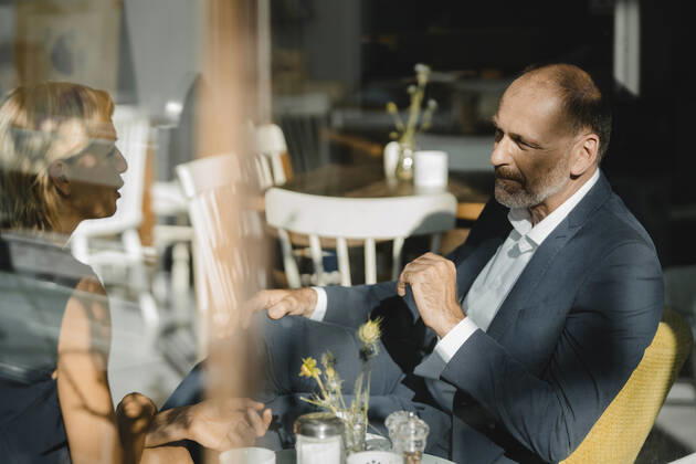 Businessman and woman having a meeting in a coffee shop model released Symbolfoto property released KNSF06367