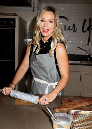 December 10, 2019, New York, New York, USA: Actress JENNIE GARTH from Beverly Hills 90210 uses a rolling pin at the partnership launch of Shipt, a grocery delivery service and kitchenware retailer Sur La Table. New York USA - ZUMAk03_ 20191210_zaf_k03_101 Copyright: xNancyxKaszermanx