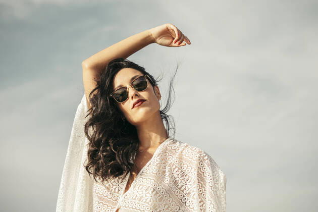 Creative Highlights Symbolfotos Portrait of young woman with raised arm and sunglasses model released Symbolfoto  MTBF00231