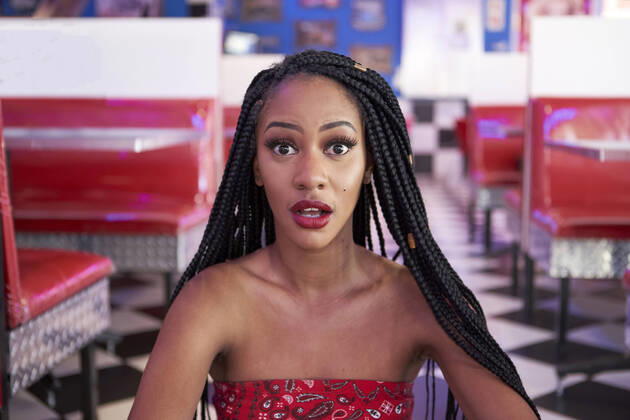 Creative Highlights Symbolfotos Portrait of a young woman with braided hairstyle in an american diner restaurant model released Symbolfoto property released  VEGF01197