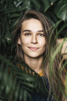 Creative Highlights Symbolfotos Portrait of a young woman amidst green plants model released Symbolfoto property released  VPIF01892