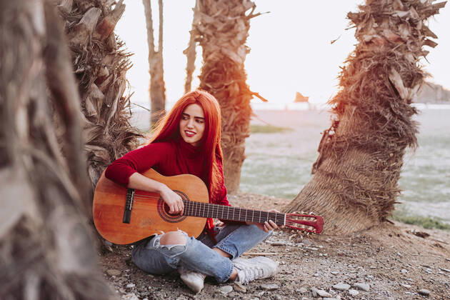 Creative Highlights Symbolfotos Portrait of young woman playing guitar on the beach, Almunecar, Spain model released Symbolfoto  LJF01213