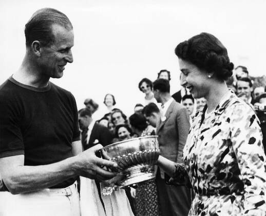 British Royalty. Duke of Edinburgh Prince Philip being presented a winning polo trophy by Queen Elizabeth II, Windsor Great Park, Windsor, England, 1961. Courtesy Everett Collection PUBLICATIONXNOTxINxCANxCHNxFRAxITAxJPNxNORxPOLxRUSxESPxUKxUSA Copyright: xCourtesyxEverettxCollectionx PBDQUEL EC071