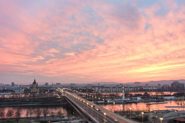 Vienna city center, river Donau (Danube), bridge Reichsbrücke, church Franz von Assisi, cathedral Stephansdom, Ferris Wheel in Prater, fierce sunset Wien, Vienna Wien Austria 00. overview