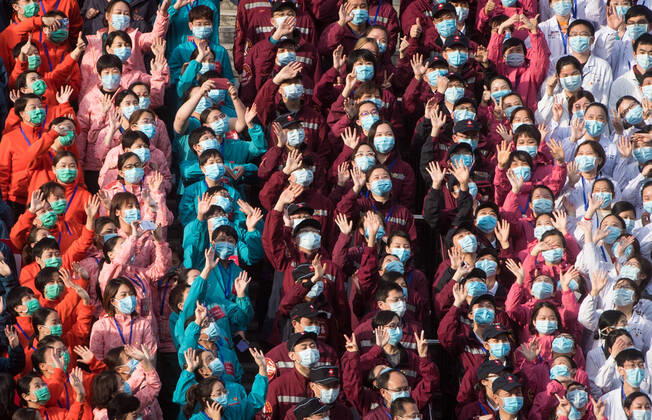 (200310) -- WUHAN, March 10, 2020 -- Medical workers wave to celebrate after the closure of a temporary hospital in Wuchang District of Wuhan, central China s Hubei Province, March 10, 2020. The last two temporary hospitals in Wuhan, the epicenter of the coronavirus outbreak in central China s Hubei Province, were shut down Tuesday, marking the closure of all 16 temporary hospitals in the city. ) CHINA-WUHAN-TEMPORARY HOSPITALS-CLOSURE (CN) XiaoxYijiu 