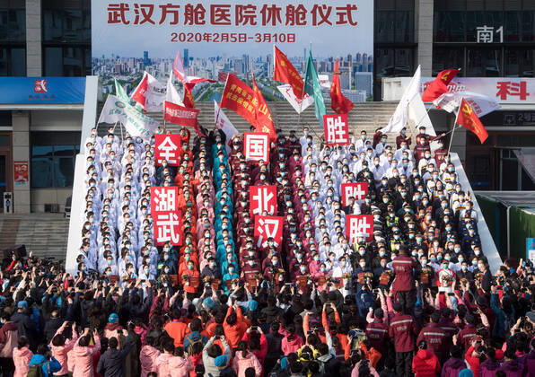 (200310) -- WUHAN, March 10, 2020 -- Medical workers celebrate after the closure of a temporary hospital in Wuchang District of Wuhan, central China s Hubei Province, March 10, 2020. The last two temporary hospitals in Wuhan, the epicenter of the coronavirus outbreak in central China s Hubei Province, were shut down Tuesday, marking the closure of all 16 temporary hospitals in the city. ) CHINA-WUHAN-TEMPORARY HOSPITALS-CLOSURE (CN) XiaoxYijiu 