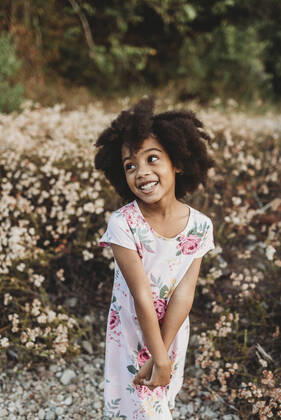 Creative Highlights Symbolfotos Portrait of young school-aged girl smiling in field of flowers San Diego, CA, United States ,model released, Symbolfoto CR_KESM200220B-196704-01