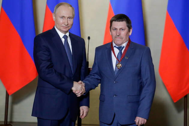 SEVASTOPOL, RUSSIA - MARCH 18, 2020: Russia s President Vladimir Putin (L) awards an Order for Merits to the Fatherland 3rd class to Cheboksary s Mostotryad-41 welder Dmitry Gavrilov for outstanding professional performance during the construction of Kerch Strait Bridge, during a ceremony at the Konstantinovskaya Batareya Konstantin Battery Museum and Exhibition Centre. Mikhail Metzel TASS  TS0D2A29