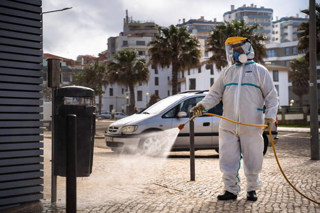 April 14, 2020, Ericeira, Portugal: An employee of the Ericeira parish council, equipped with the recommended protective materials, disinfects the street with a solution based with hypochlorite (bleach)..The municipality of Mafra had 70 cases of COVID-19 pandemic. In order to prevent the spread of the virus, the Ericeira Parish Council perform weekly street disinfection. Ericeira Portugal - ZUMAs197 20200414_zaa_s197_169 Copyright: xHenriquexCasinhasx