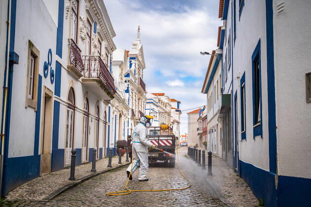 April 14, 2020, Ericeira, Portugal: An employee of the Ericeira parish council, equipped with the recommended protective materials, disinfects the street with a solution based on hypochlorite (bleach)..The municipality of Mafra had 70 cases of COVID-19 pandemic. In order to prevent the spread of the virus, the Ericeira Parish Council perform weekly street disinfection. Ericeira Portugal - ZUMAs197 20200414_zaa_s197_178 Copyright: xHenriquexCasinhasx
