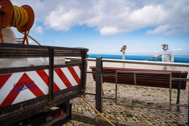 April 14, 2020, Ericeira, Portugal: An employee of the Ericeira parish council, equipped with the recommended protective materials, disinfects the street with a solution based on hypochlorite (bleach)..The municipality of Mafra had 70 cases of COVID-19 pandemic. In order to prevent the spread of the virus, the Ericeira Parish Council perform weekly street disinfection. Ericeira Portugal - ZUMAs197 20200414_zaa_s197_179 Copyright: xHenriquexCasinhasx