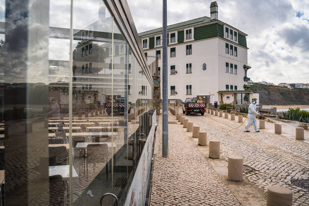 April 14, 2020, Ericeira, Portugal: An employee of the Ericeira parish council, equipped with the recommended protective materials, disinfects the street with a solution based on hypochlorite (bleach)..The municipality of Mafra had 70 cases of COVID-19 pandemic. In order to prevent the spread of the virus, the Ericeira Parish Council perform weekly street disinfection. Ericeira Portugal - ZUMAs197 20200414_zaa_s197_190 Copyright: xHenriquexCasinhasx