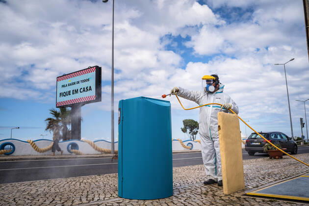 April 14, 2020, Ericeira, Portugal: An employee of the Ericeira parish council, equipped with the recommended protective materials, disinfects the street with a solution based on hypochlorite (bleach)..The municipality of Mafra had 70 cases of COVID-19 pandemic. In order to prevent the spread of the virus, the Ericeira Parish Council perform weekly street disinfection. Ericeira Portugal - ZUMAs197 20200414_zaa_s197_192 Copyright: xHenriquexCasinhasx