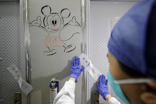 (200415) -- WUHAN, April 15, 2020 -- A nurse seals off a gate of Leishenshan (Thunder God Mountain) Hospital in Wuhan, capital of central China s Hubei Province, April 15, 2020. Wuhan Leishenshan (Thunder God Mountain) Hospital ceased operation in Wuhan on Wednesday as the coronavirus epidemic wanes. ) CHINA-HUBEI-WUHAN-LEISHENSHAN HOSPITAL-RETIRING (CN) ShenxBohan 