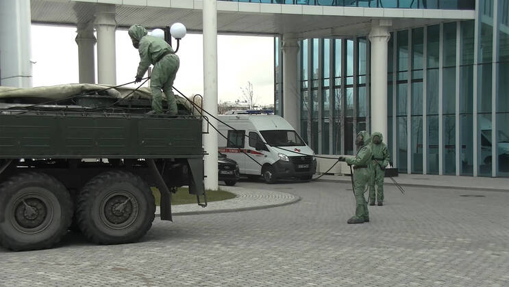 ST PETERSBURG, RUSSIA - APRIL 15, 2020: Pictured in this video grab are servicemen of Russian Army chemical, biological and radiological (CBR) defence troops in hazmat suits during disinfection of premises of the St Petersburg branch of the Girls Boarding School of the Russian Ministry during the pandemic of the novel coronavirus disease (COVID-19). A team of 20 Russian soldiers took carried out the disinfection. As of 15 April 2020, Russia has reported more than 21,100 confirmed cases of the novel coronavirus infection, with more than 800 confirmed cases in St Petersburg. Video grab. Russian Army Western Military District Press Office TASS  TS0D5C8B