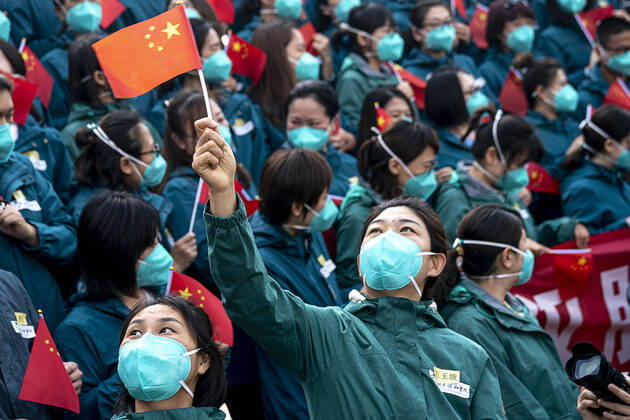 (200415) -- WUHAN, April 15, 2020 -- A medical worker from the Peking Union Medical College Hospital waves the Chinese national flag in Wuhan, capital of central China s Hubei Province, April 15, 2020. The last medical assistance team started leaving Hubei Province Wednesday as the COVID-19 epidemic in the hard-hit province has been subdued. The medical team consisting of over 180 medical workers from the Peking Union Medical College Hospital arrived in the provincial capital of Wuhan on Jan. 26. ) CHINA-HUBEI-WUHAN-LAST MEDICAL ASSISTANCE TEAM-LEAVING (CN) XiongxQi 