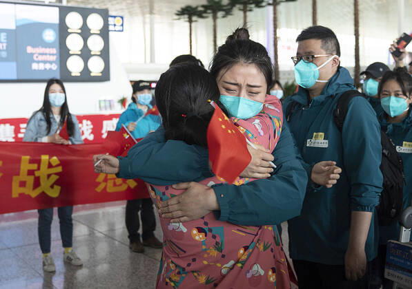 (200415) -- WUHAN, April 15, 2020 -- A medical worker from the Peking Union Medical College Hospital bids farewell to a local medical worker at the Wuhan Tianhe International Airport in Wuhan, capital of central China s Hubei Province, April 15, 2020. The last medical assistance team started leaving Hubei Province Wednesday as the COVID-19 epidemic in the hard-hit province has been subdued. The medical team consisting of over 180 medical workers from the Peking Union Medical College Hospital arrived in the provincial capital of Wuhan on Jan. 26. ) CHINA-HUBEI-WUHAN-LAST MEDICAL ASSISTANCE TEAM-LEAVING (CN) XiongxQi 