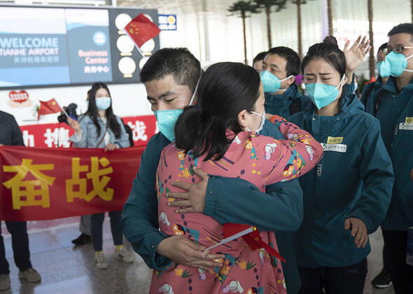(200415) -- WUHAN, April 15, 2020 -- A medical worker from the Peking Union Medical College Hospital bids farewell to a local medical worker at the Wuhan Tianhe International Airport in Wuhan, capital of central China s Hubei Province, April 15, 2020. The last medical assistance team started leaving Hubei Province Wednesday as the COVID-19 epidemic in the hard-hit province has been subdued. The medical team consisting of over 180 medical workers from the Peking Union Medical College Hospital arrived in the provincial capital of Wuhan on Jan. 26. ) CHINA-HUBEI-WUHAN-LAST MEDICAL ASSISTANCE TEAM-LEAVING (CN) XiongxQi 