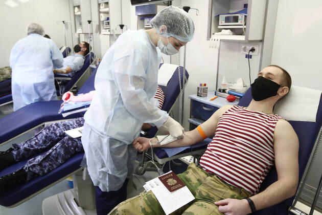 MOSCOW REGION, RUSSIA - APRIL 15, 2020: Servicemen of Russia s Federal National Guard Service (Rosgvardia) donating blood during a blood donating campaign titled From Heart to Heart at the Moscow Region Main Directorate of Russia s Federal National Guard Service (Rosgvardia) in the town of Reutov. The campaign is organized by medical brigades of a special medical complex fitted with air disinfection equipment. Sergei Fadeichev TASS  TS0D5CF4