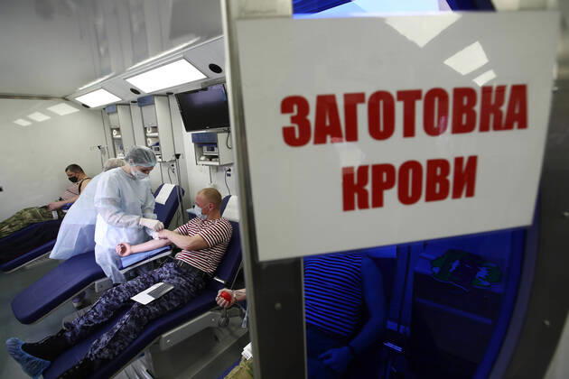 MOSCOW REGION, RUSSIA - APRIL 15, 2020: Servicemen of Russia s Federal National Guard Service (Rosgvardia) donating blood during a blood donating campaign titled From Heart to Heart at the Moscow Region Main Directorate of Russia s Federal National Guard Service (Rosgvardia) in the town of Reutov. The campaign is organized by medical brigades of a special medical complex fitted with air disinfection equipment. Sergei Fadeichev TASS  TS0D5CF5