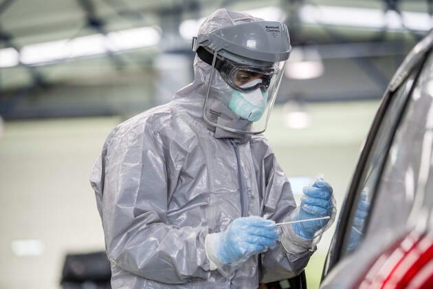 April 15, 2020, Granada, Spain: A health worker in a protective suit takes a sample for a PCR test..During the coronavirus crisis, at the ITV (technical inspection of vehicles) center in Albolote PCR tests (polymerase chain reaction) are carried out on workers of the security forces and staff of nursing homes to detect Covid 19. Granada Spain - ZUMAs197 20200415_zaa_s197_097 Copyright: xCarlosxGilx